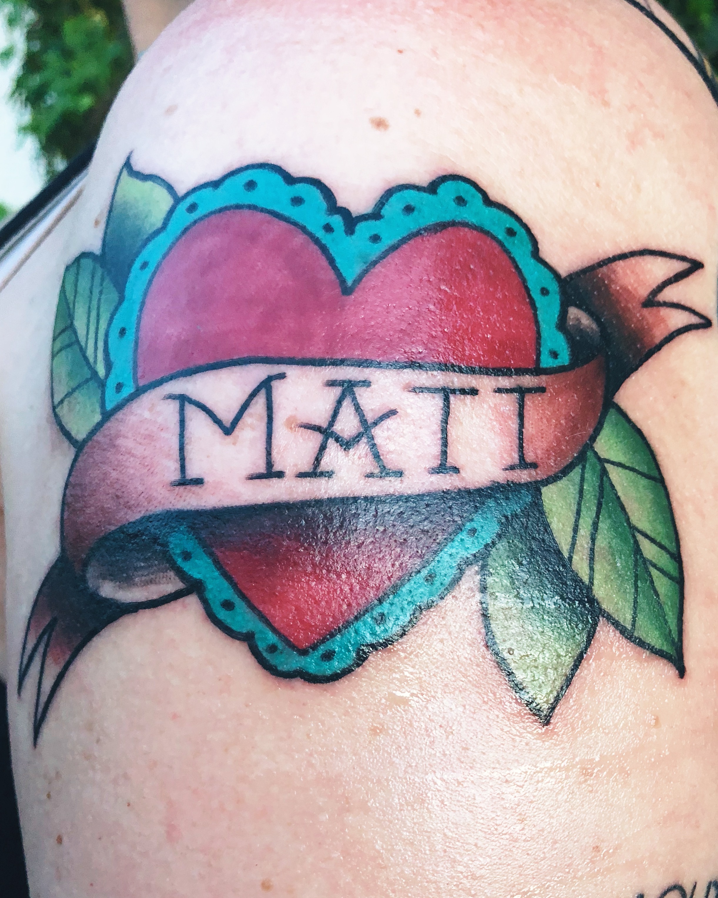 Couples traditional heart name tattoo.